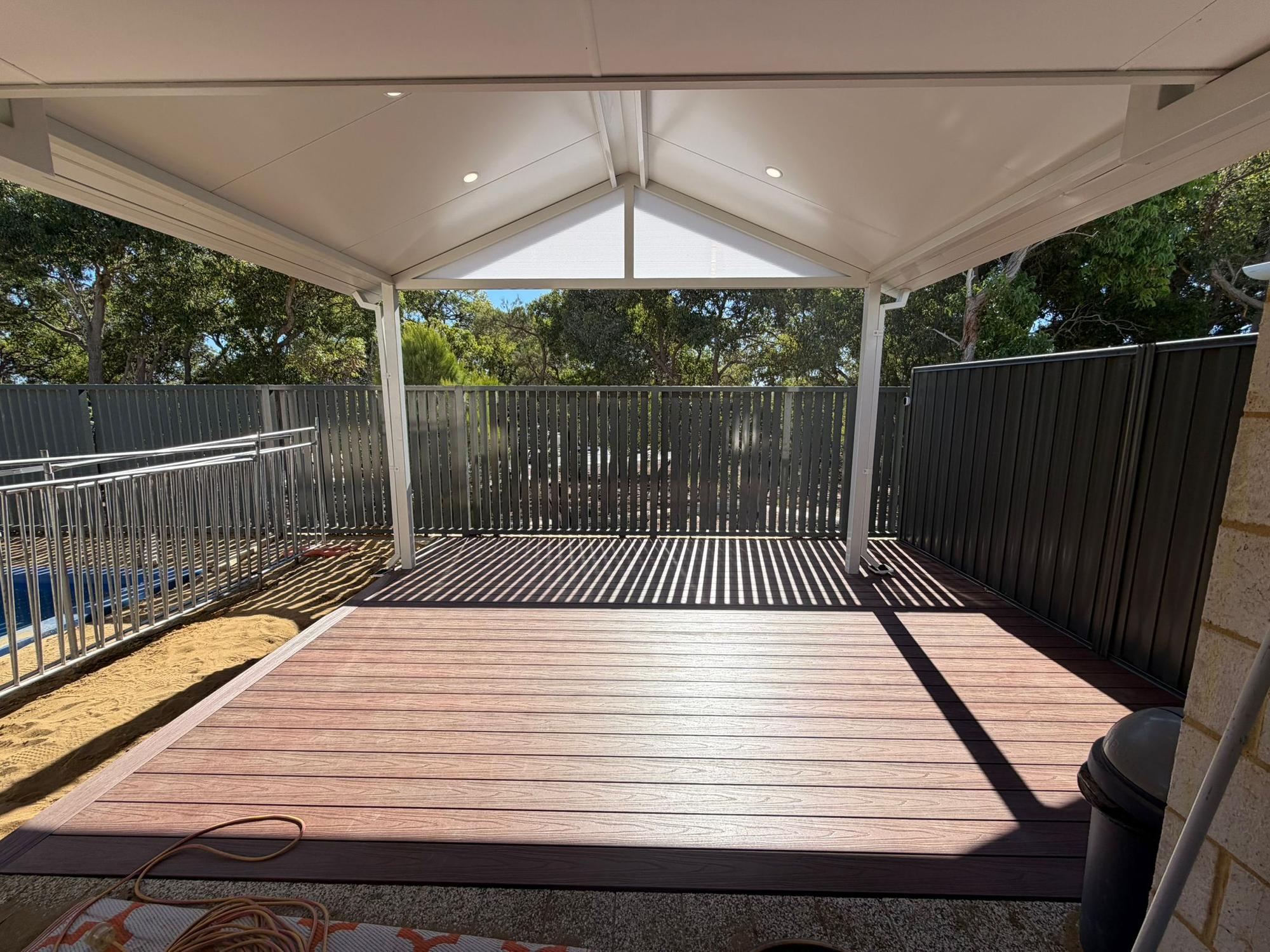 Gable patio with merbau decking and downlights at dusk
