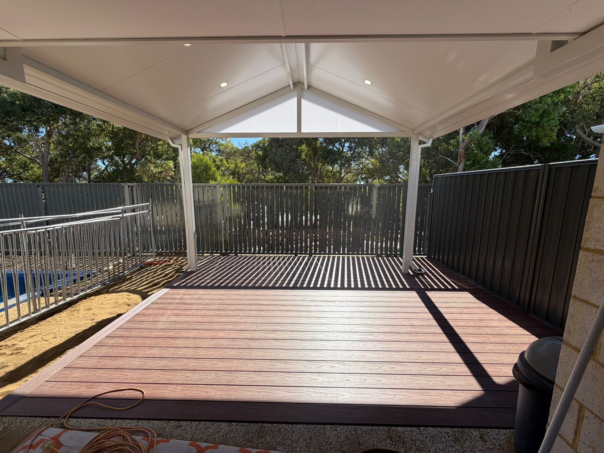 Gable patio with composite decking, pool fencing and downlights