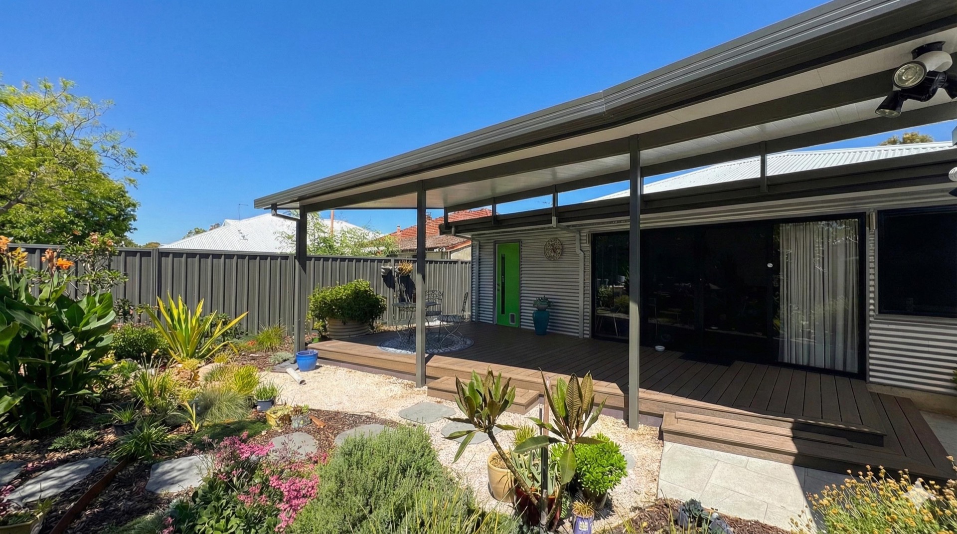 Flat patio with composite decking and landscaped garden